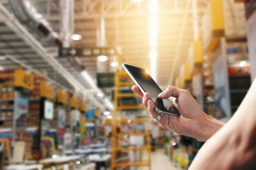 Person using wifi on phone in a warehouse